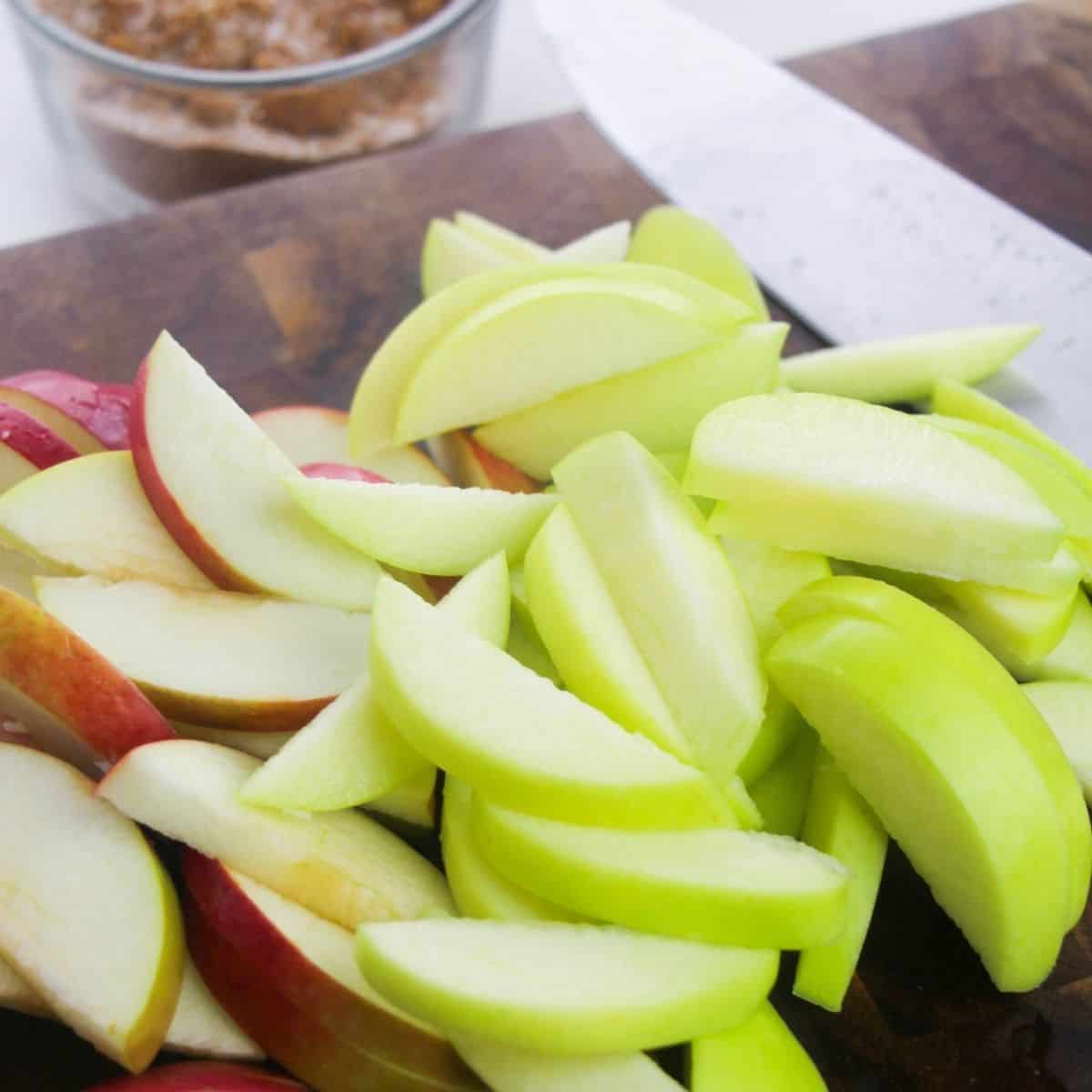 Sliced apples in a pan being fried in butter.