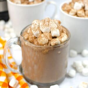 hot chocolate in a clear mug topped with marshmallows