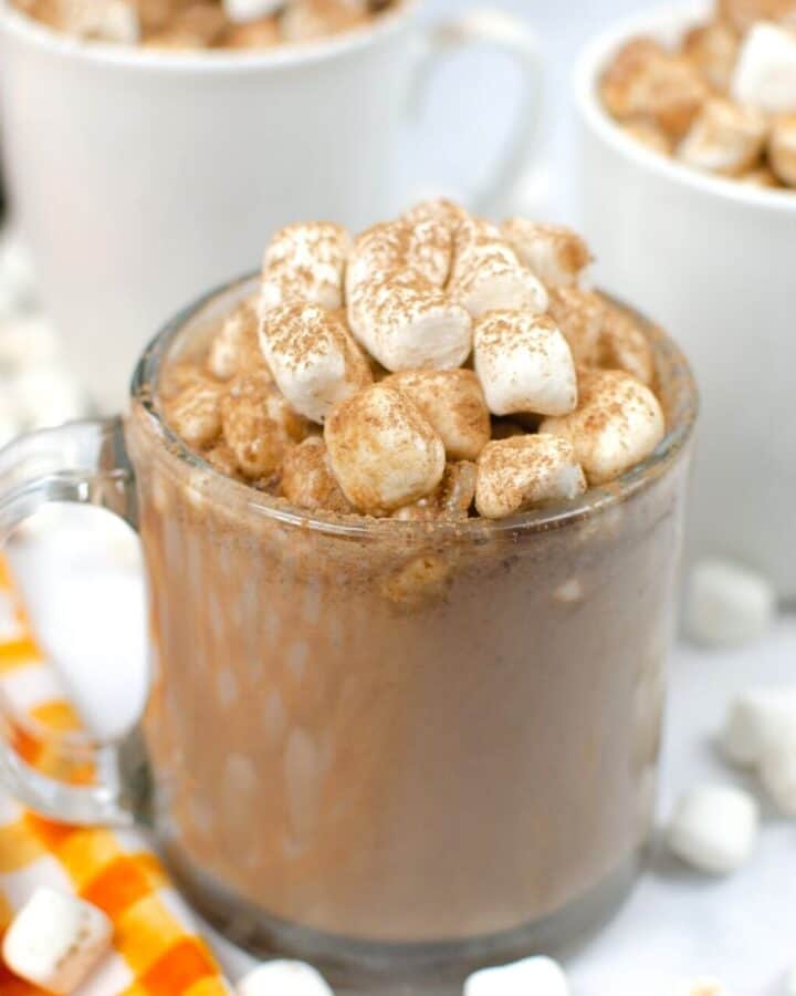 hot chocolate in a clear mug topped with marshmallows