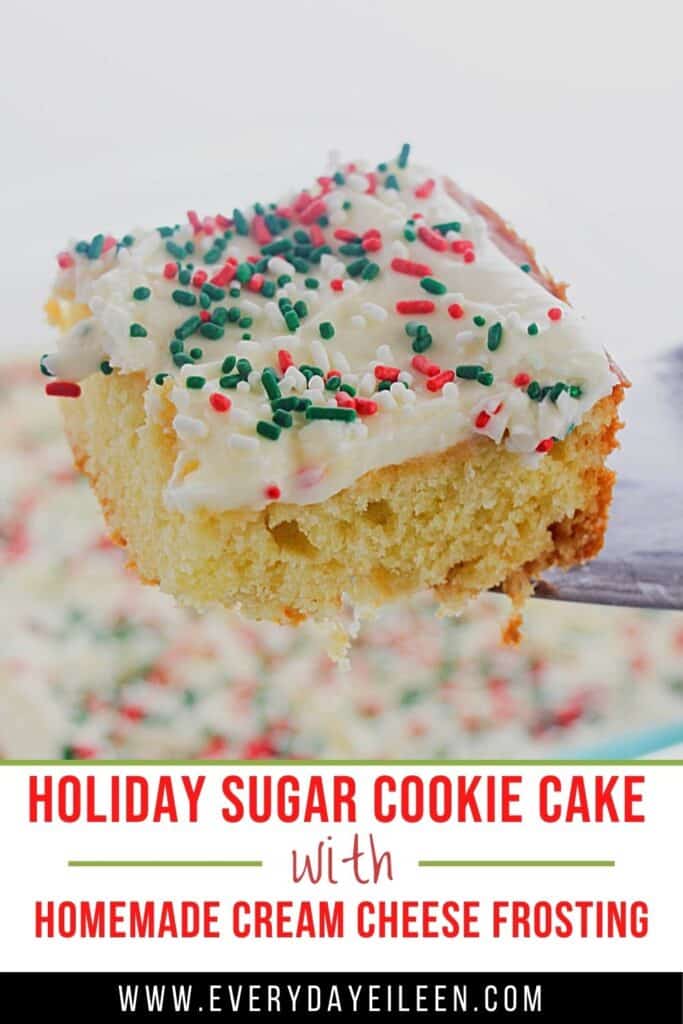 A slice of cake on a spatula with cream cheese frosting and holiday sprinkles