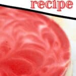 A swirled red velvet cheesecake on a white platter
