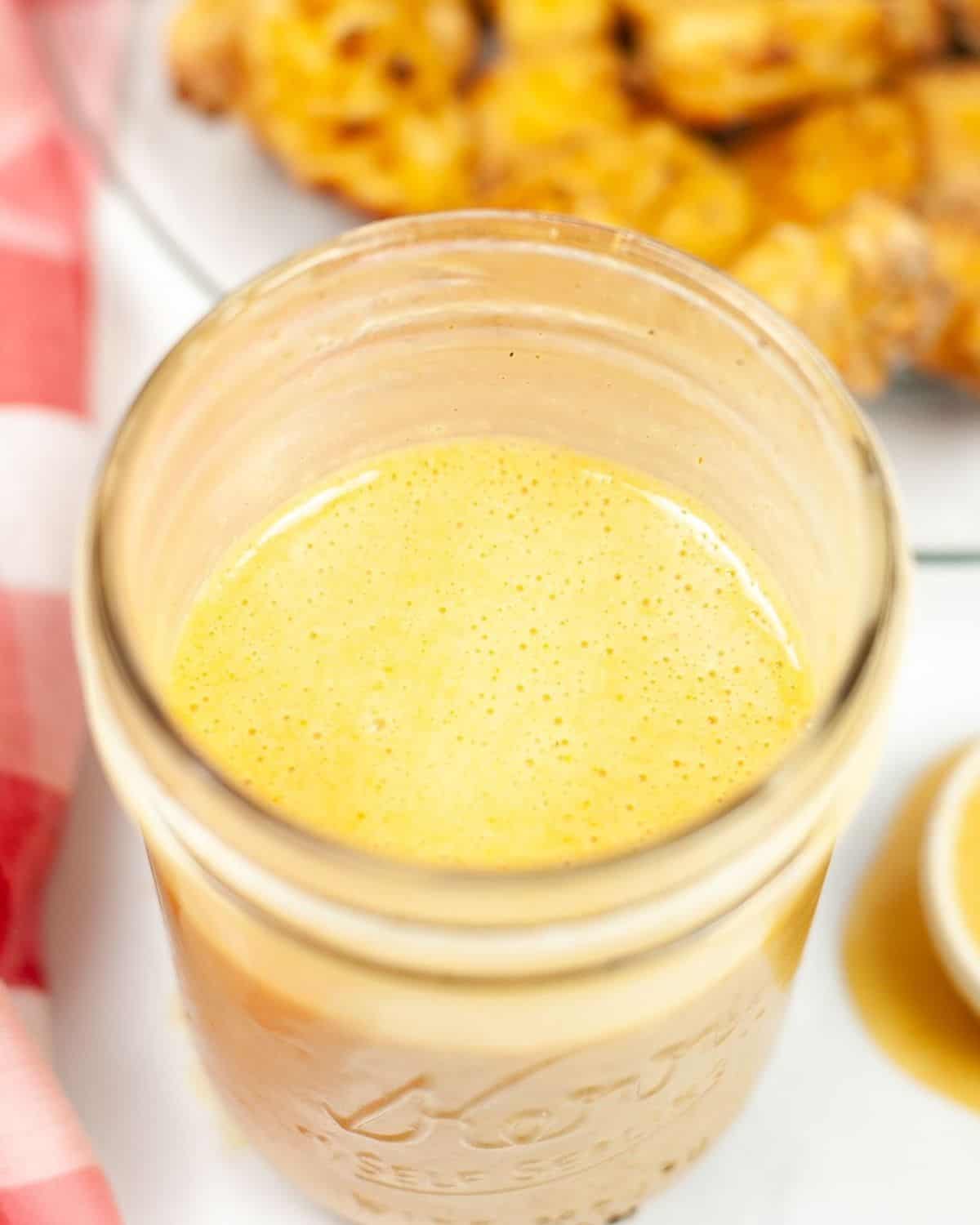 An overhead view of Chik-fil-A sauce in a clear mason jar.