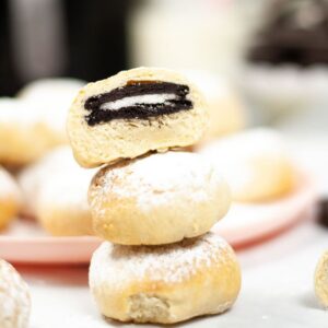 Three fried Oreos stacked together with the top one sliced in half.