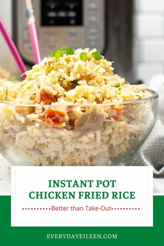 A glass bowl filled with cooked white rice, chicken and topped with green onions.