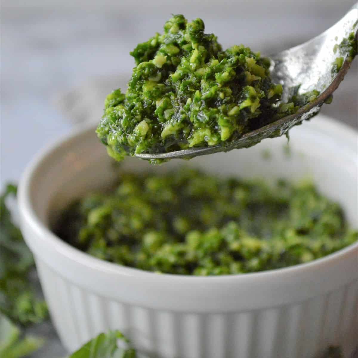 Kale pesto without nuts on a spoon. 