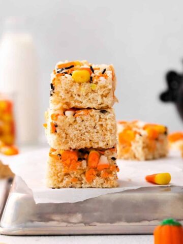 Rice Krispie treats stacked on a silver pan.