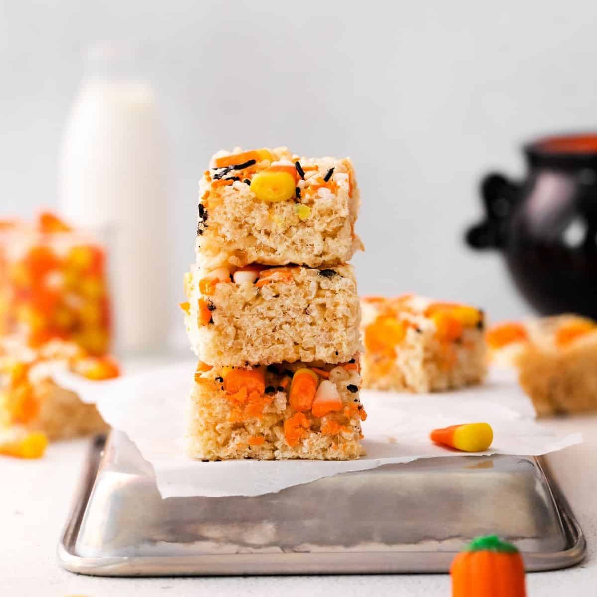 Rice Krispie treats stacked on a silver pan.