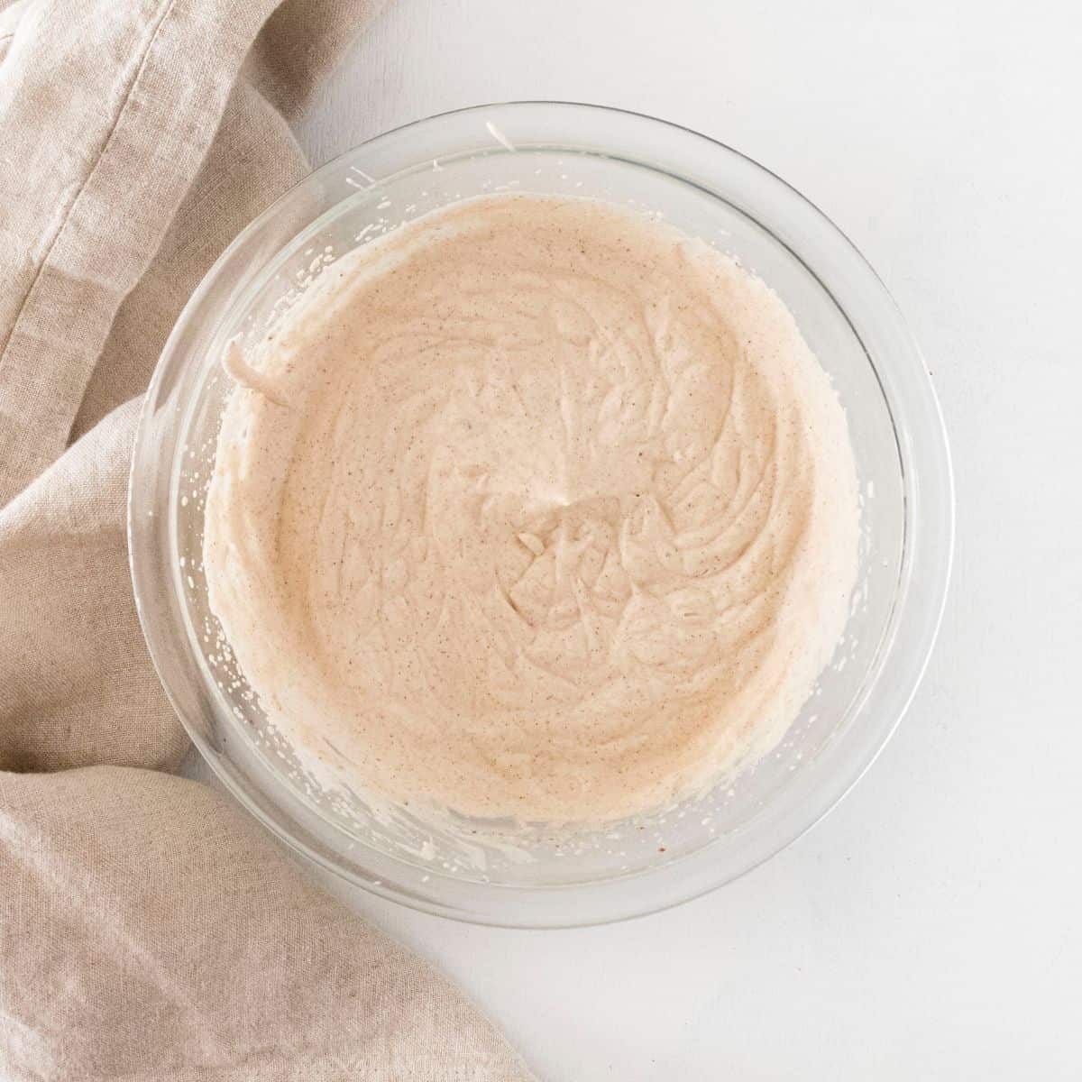 A glass bowl with whipped mousse in the bowl.