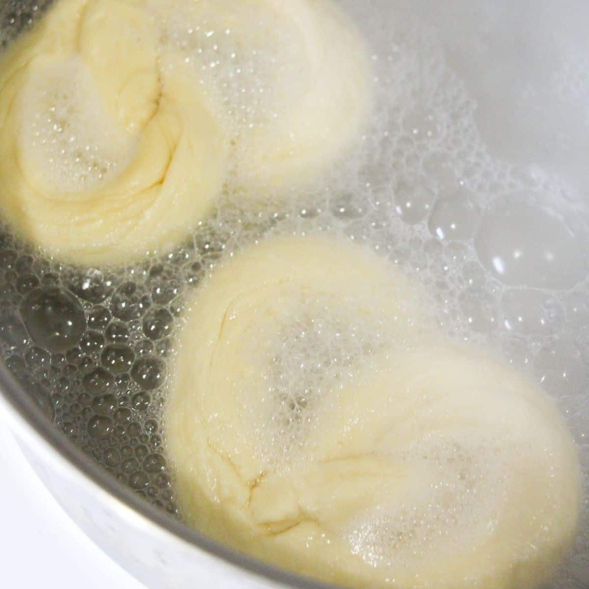 Pretzel dough in boiling water. 