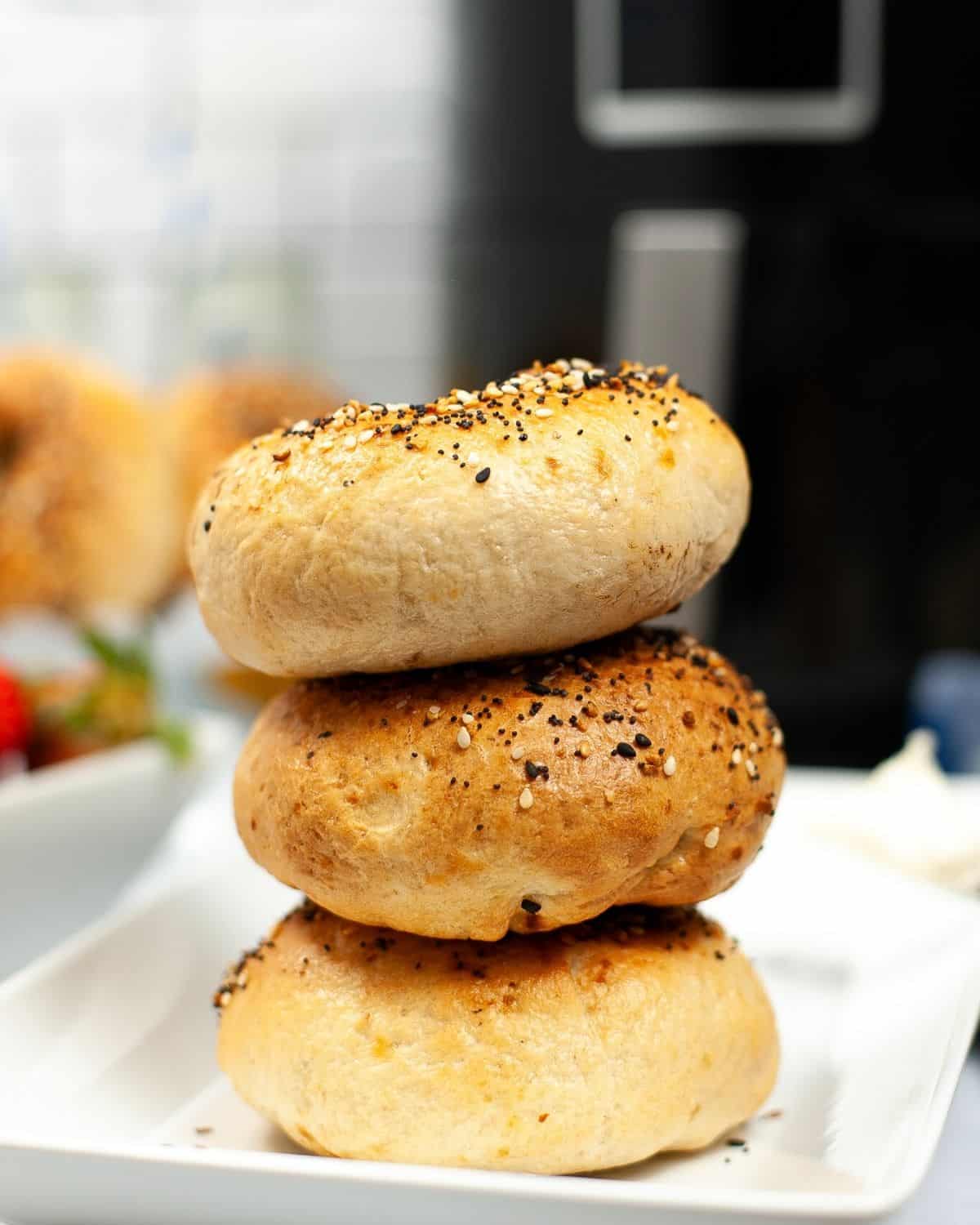 A stack of air fryer baked bagels seasoned with everything bagel seasoning. 