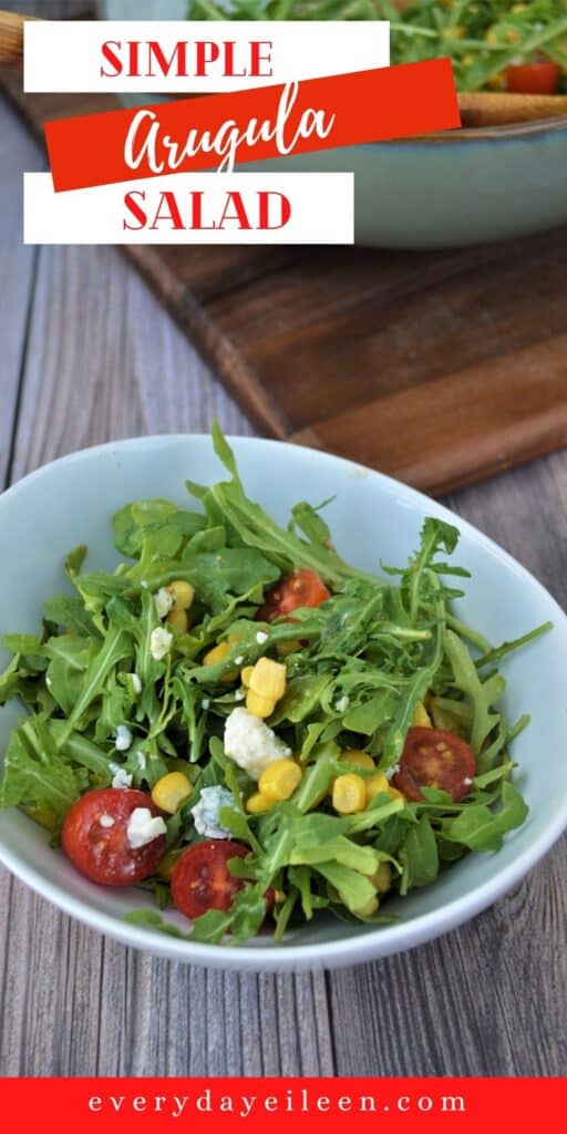 A green salad with corn and tomatoes in a white bowl.