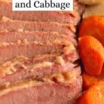 A white platter with sliced corned beef and cabbage on the tray with sliced carrots and potatoes.