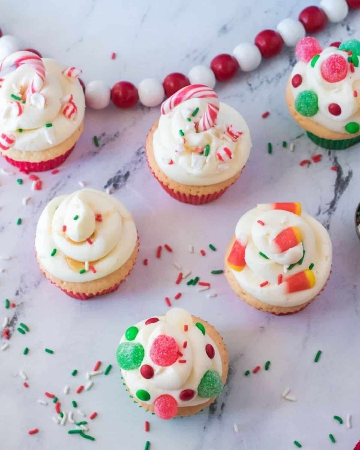 An overhead view of buddy the elf cupcakes with gumdrops, sprinkles, and candy corn. 