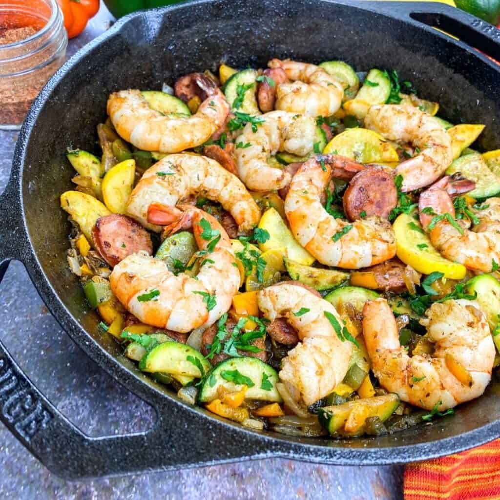 Cooked Cajun shrimp and sauce with vegetables. 