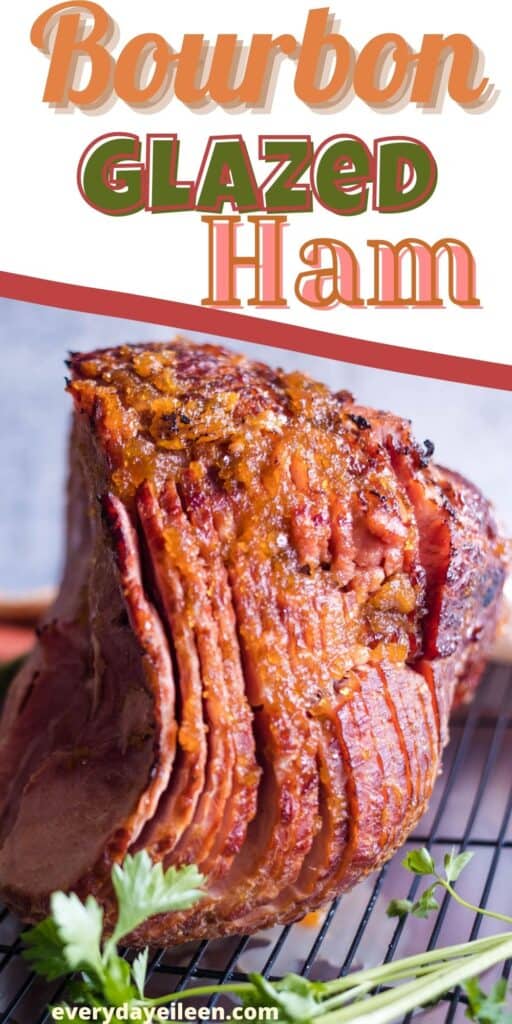A spiral ham on a wire rack with parsley in front of the ham.