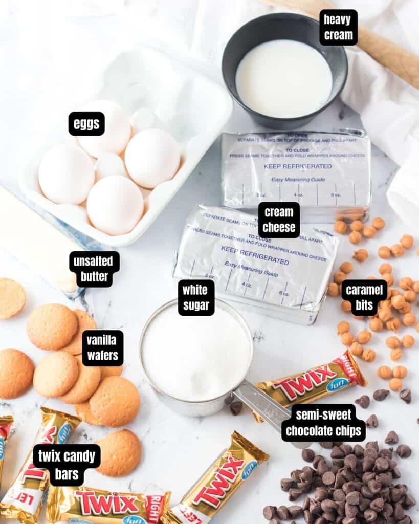 Ingredients to make twix cheesecake with text overlay.