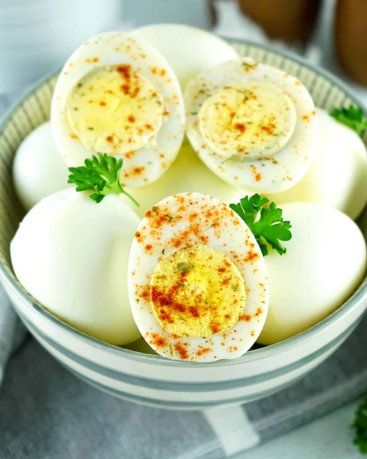 Hard boiled eggs made in the air fryer topped with paprika and chopped parsley. 