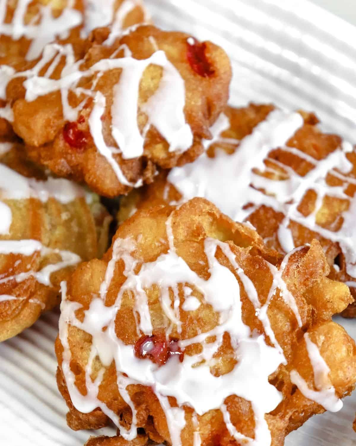 Cherry fritters with a glaze on a plate. 