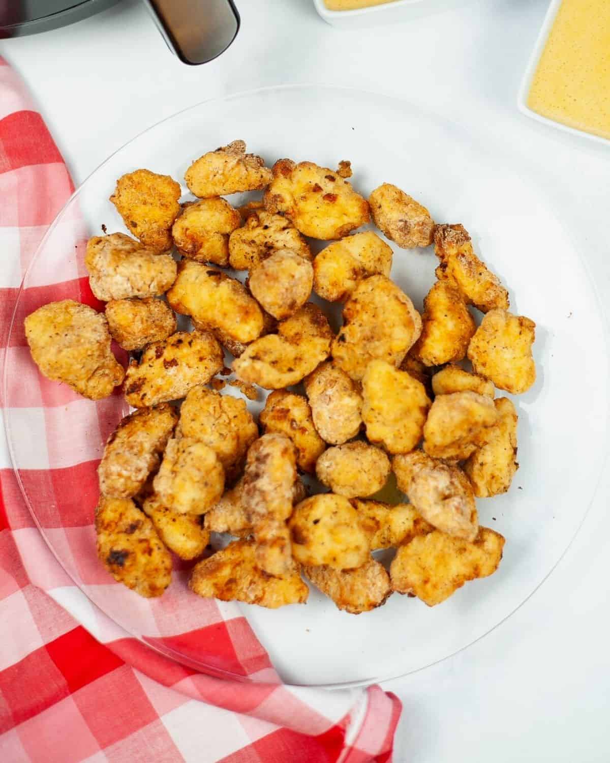 Air fryer chick fil a nuggets on a plate. 