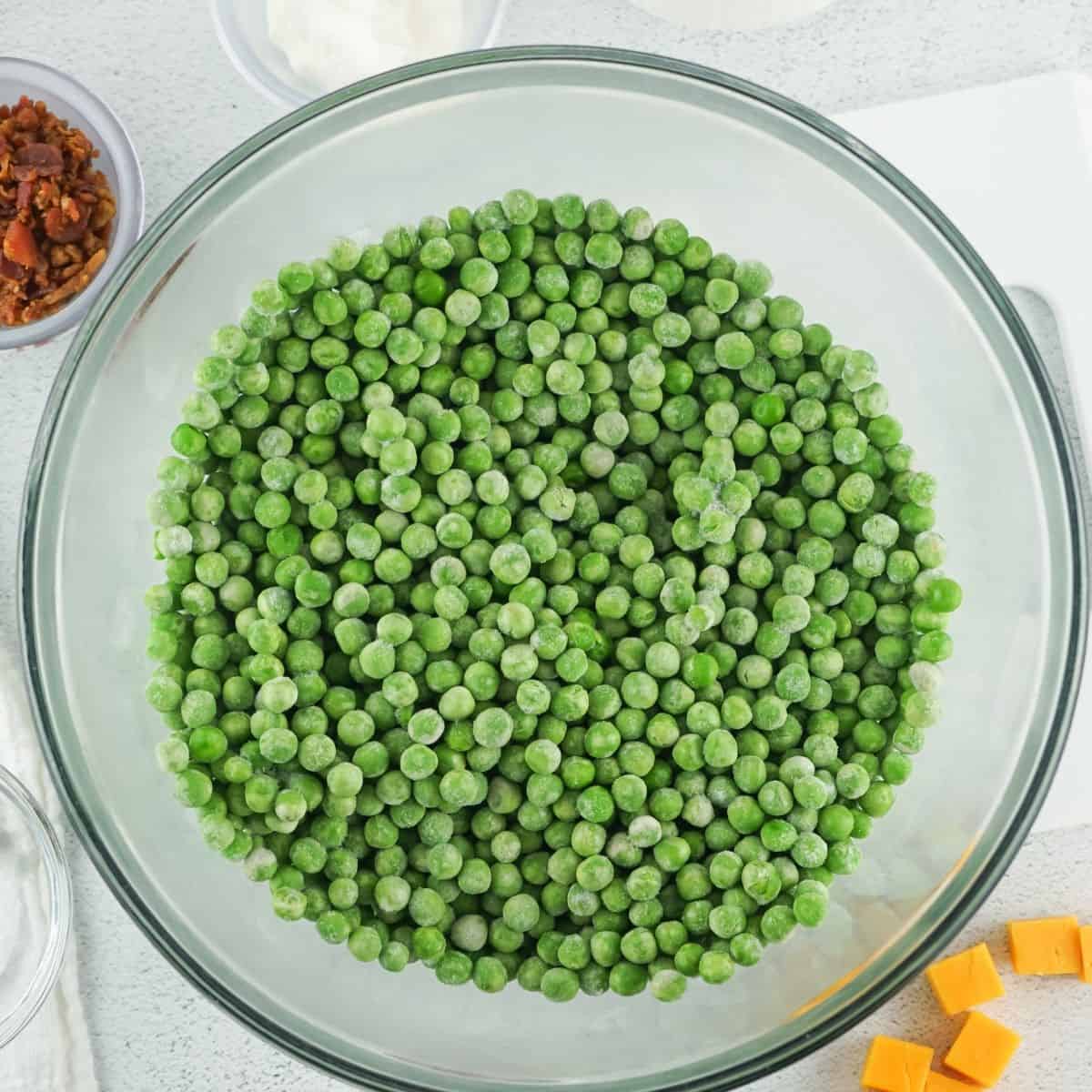 A bowl of frozen peas to make a creamy pea salad. 