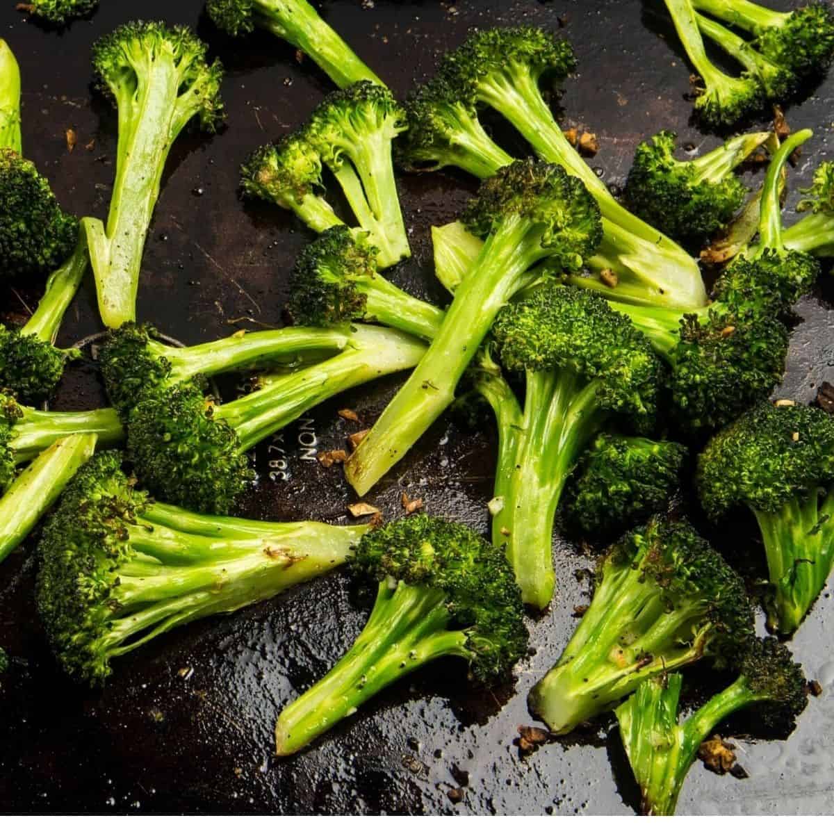 Broccoli crowns on a baking sheet.