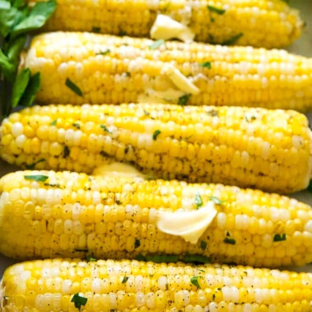 Roast corn topped with butter and herb.