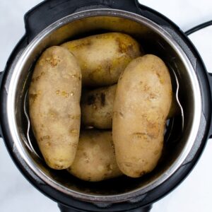 An instant pot filled to the trivet top with russet potatoes