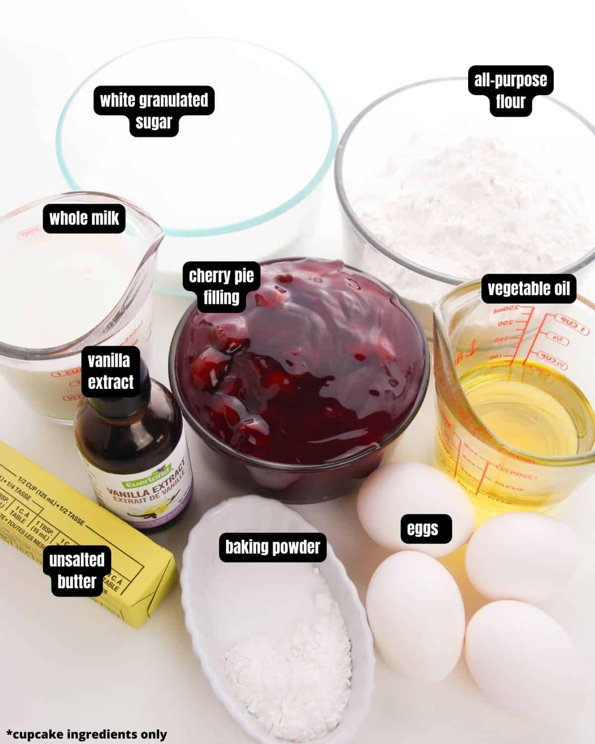 Ingredients to make homemade vanilla cupcakes with cherry pie fillings.