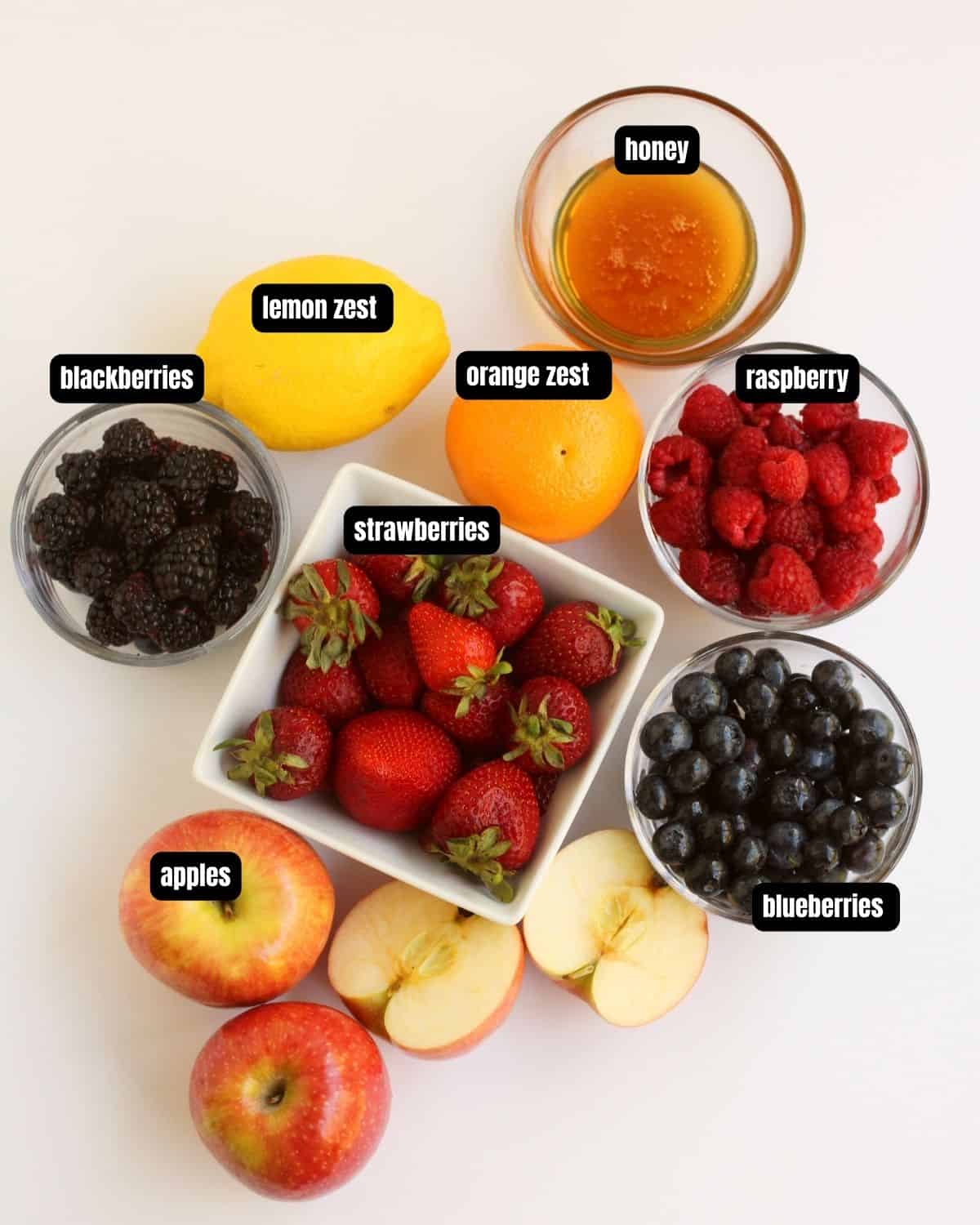Ingredients with a text overlay of the ingredients to make fruit salad. 