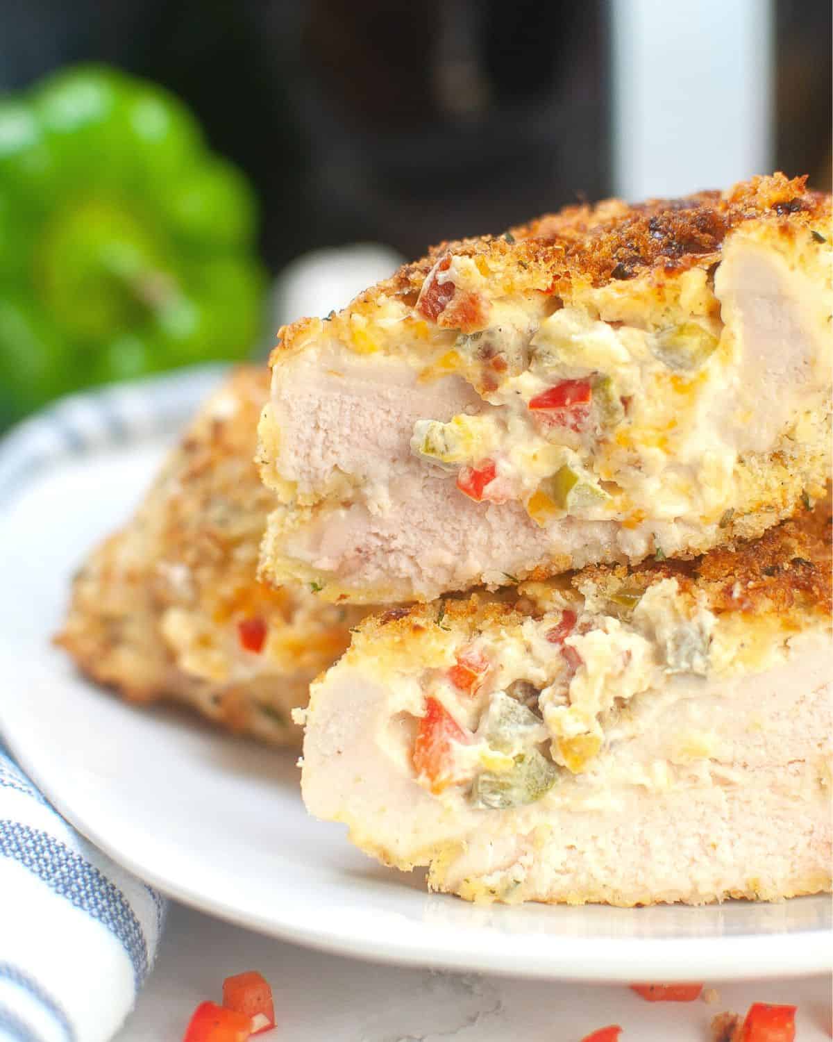 Air fryer stuffed chicken sliced to see the creamy bacon and bell pepper stuffing. 