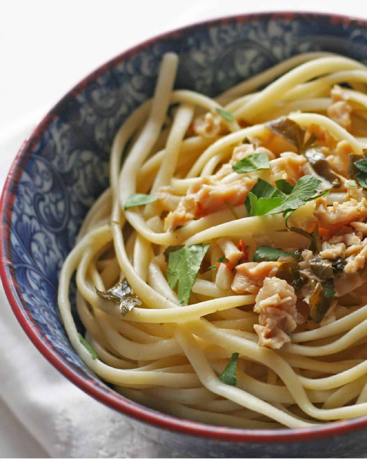 A bowl of clam sauce and linguine.