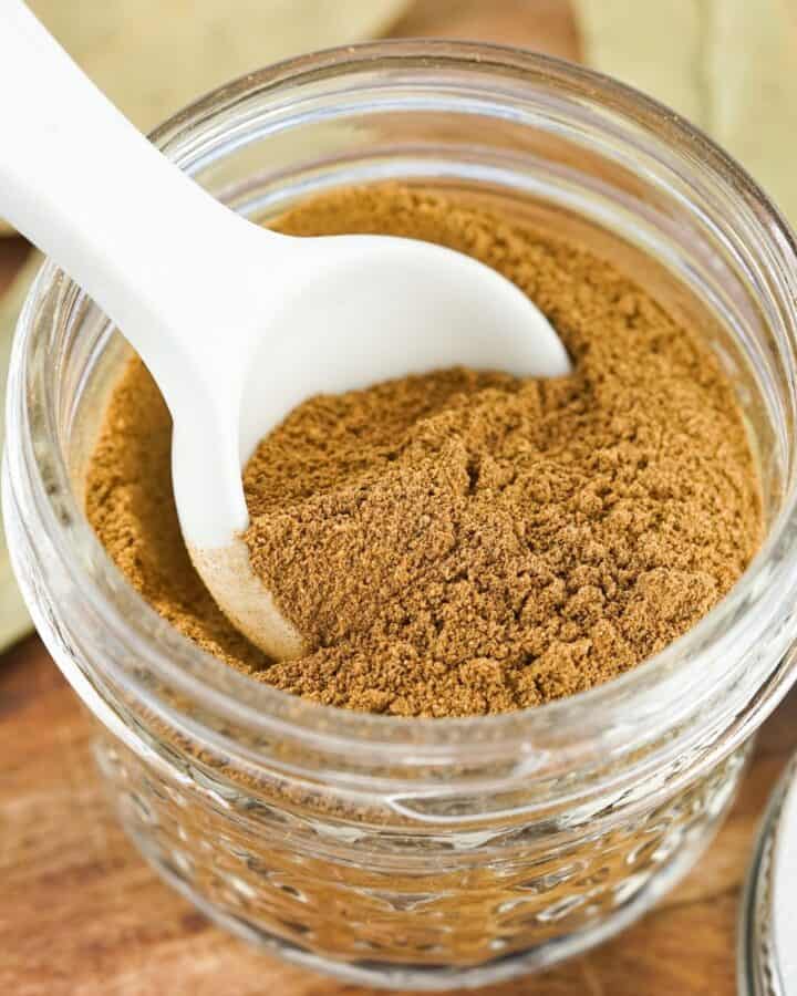 A mason jar with a homemade spice mix to use for savory apple dishes.