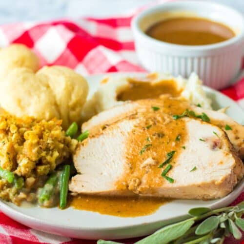 A plate with turkey, stuffing, and mashed potatoes in a plate.