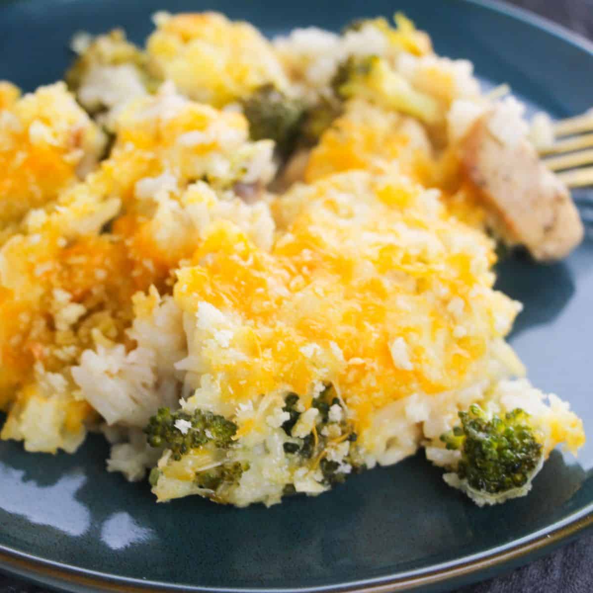 A blue bowl with rice, broccoli, chicken topped with melted cheddar cheese.