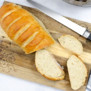 A loaf of french bread made in the instant pot on a cutting board.