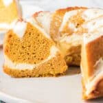 A slice of a pumpkin bundt cake with a swirl on a white plate.