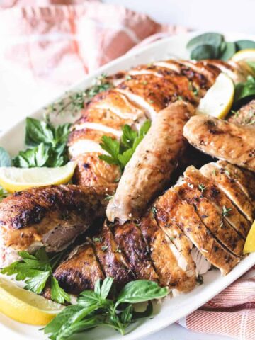 A sliced whole roasted turkey on a platter.