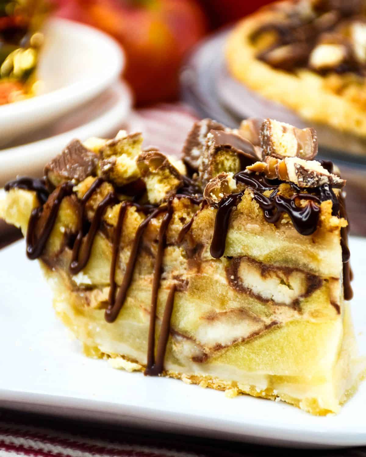 A slice of twix caramel apple crumble on a plate.