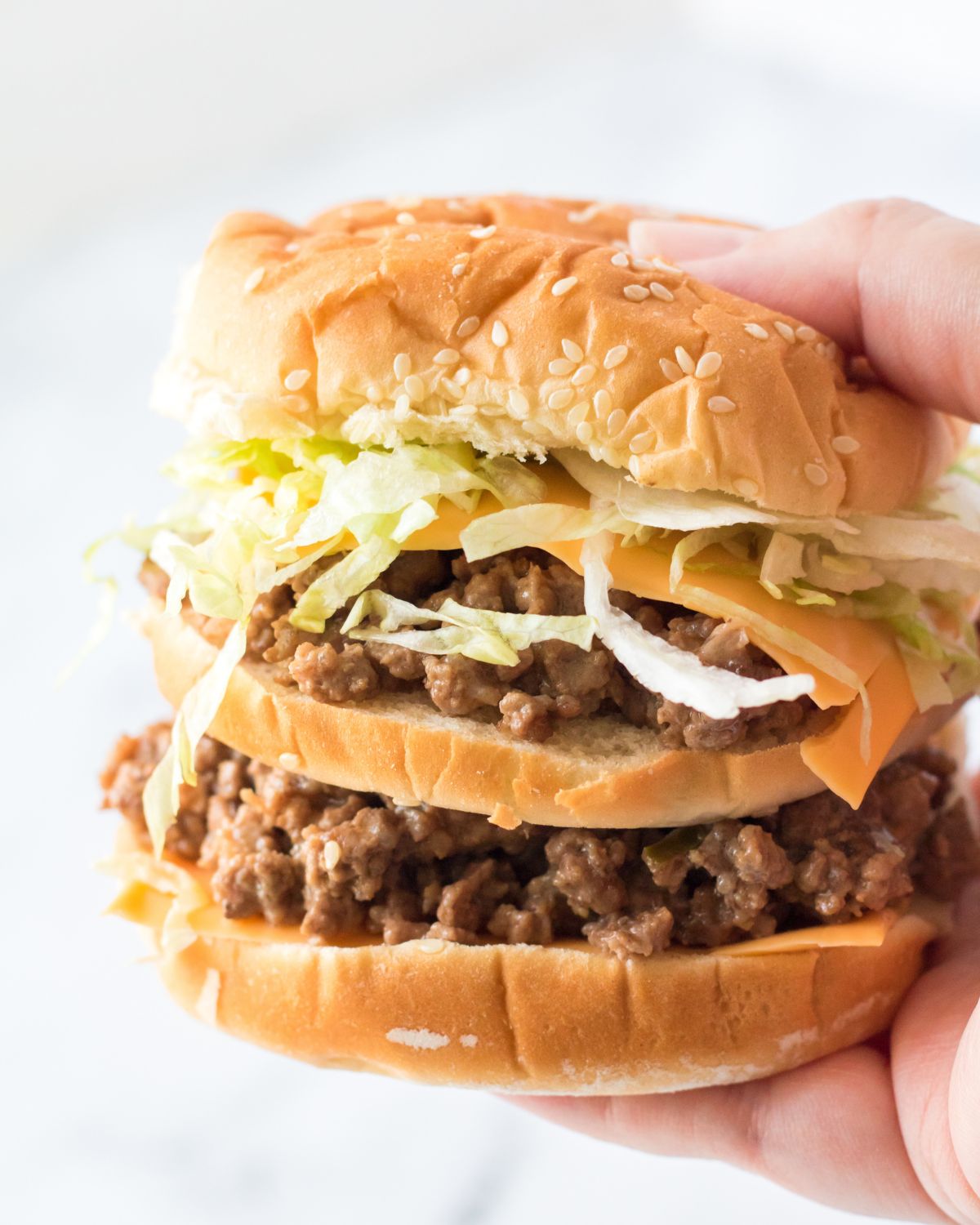 A big mac sloppy joe in a double decker sesame bun.