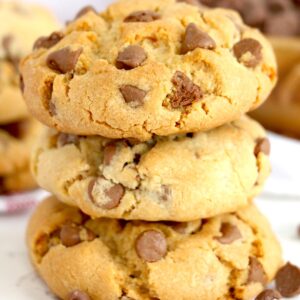 Stacked fat and chewy chocolate chip cookies.