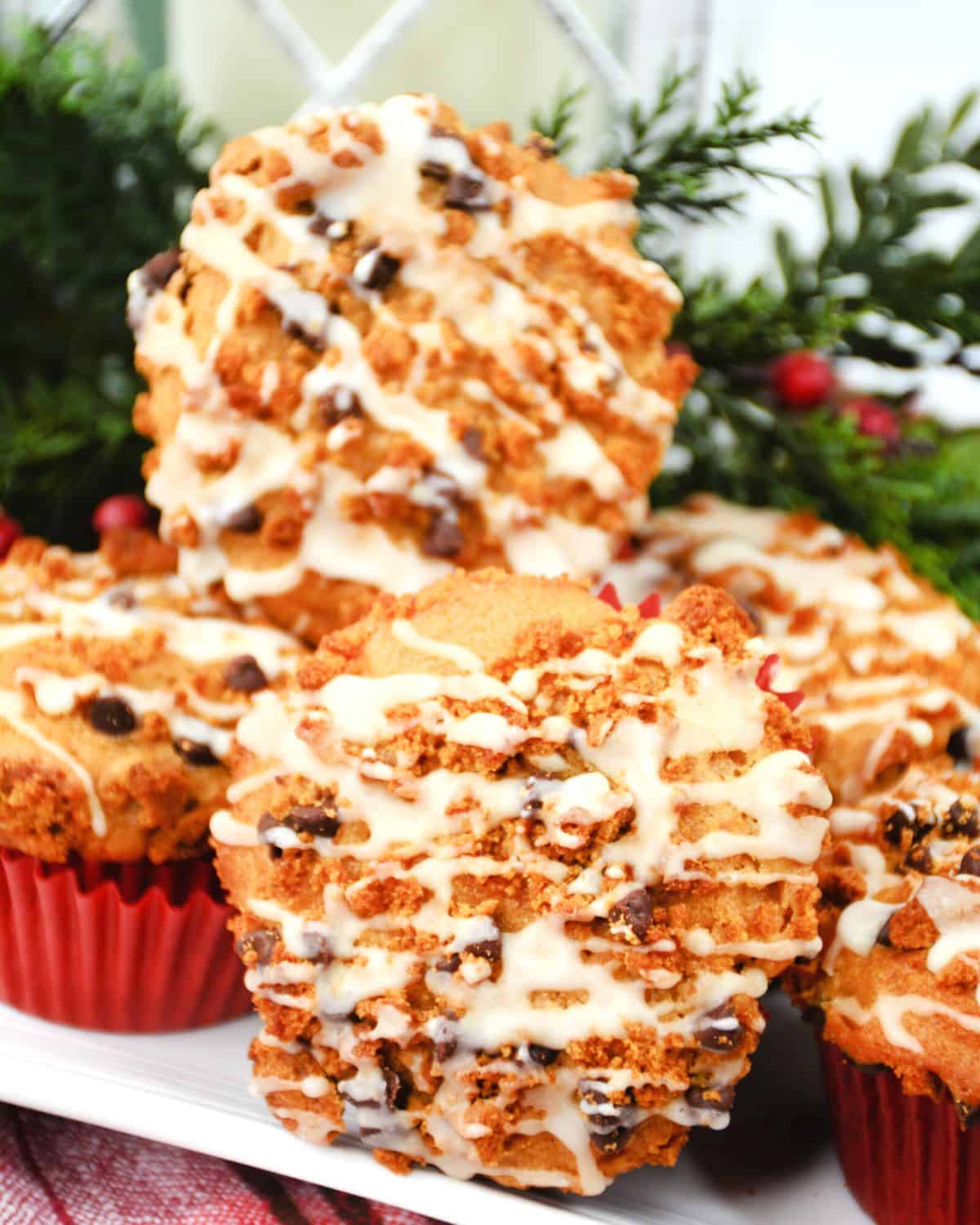 Gingerbread muffins stacked on a plate with a vanilla glaze.