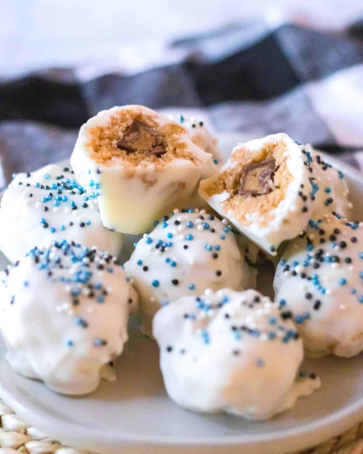 A platter of white chocolate covered peanut butter rice krispy balls. 