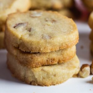 A stack of pecan sandie cookies.