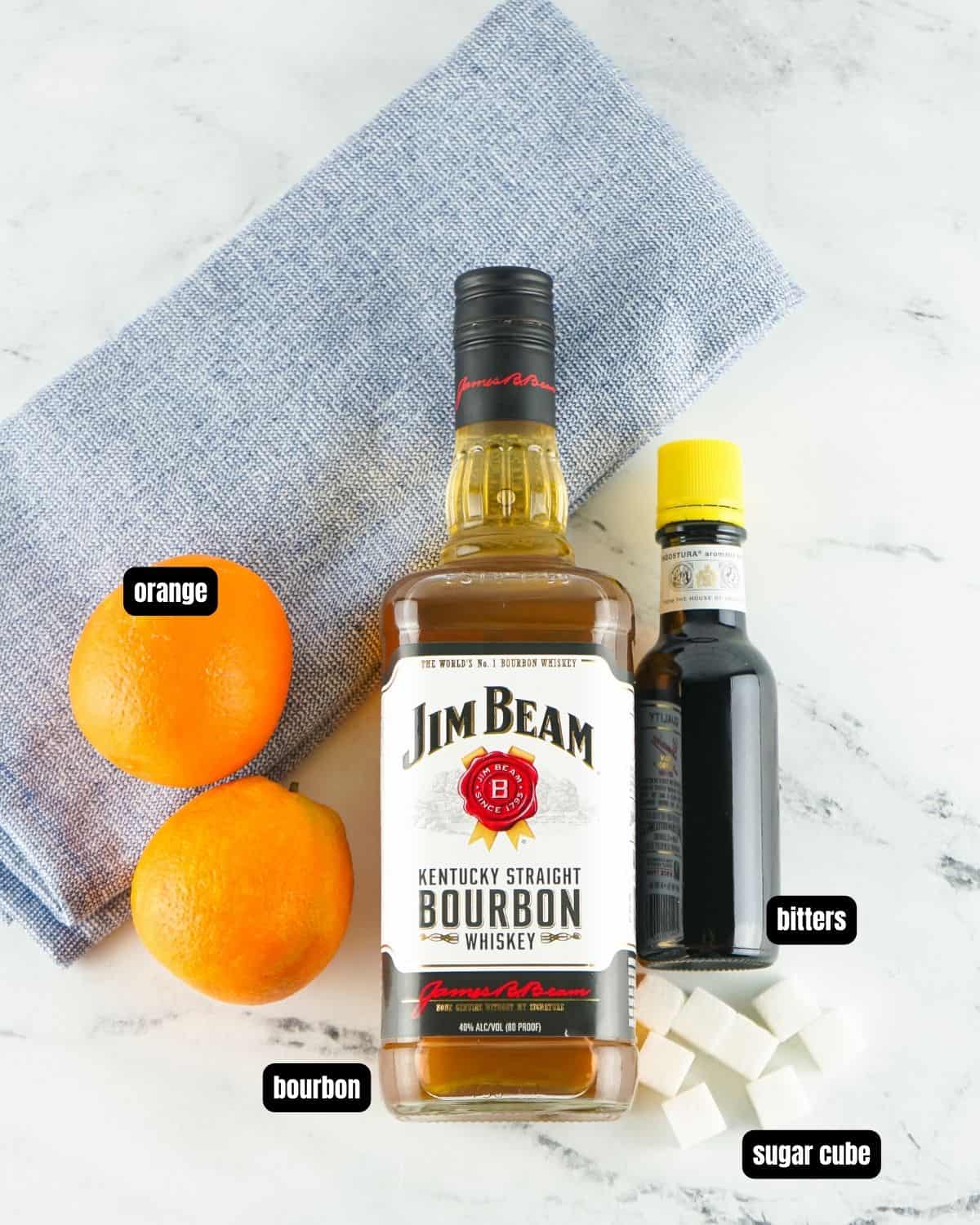 Ingredients with text overlay to make old fashioned.