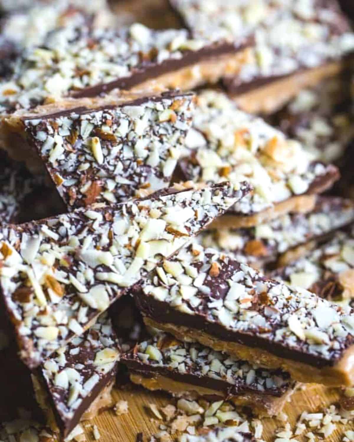 Almond roca candy stacked on a plate.