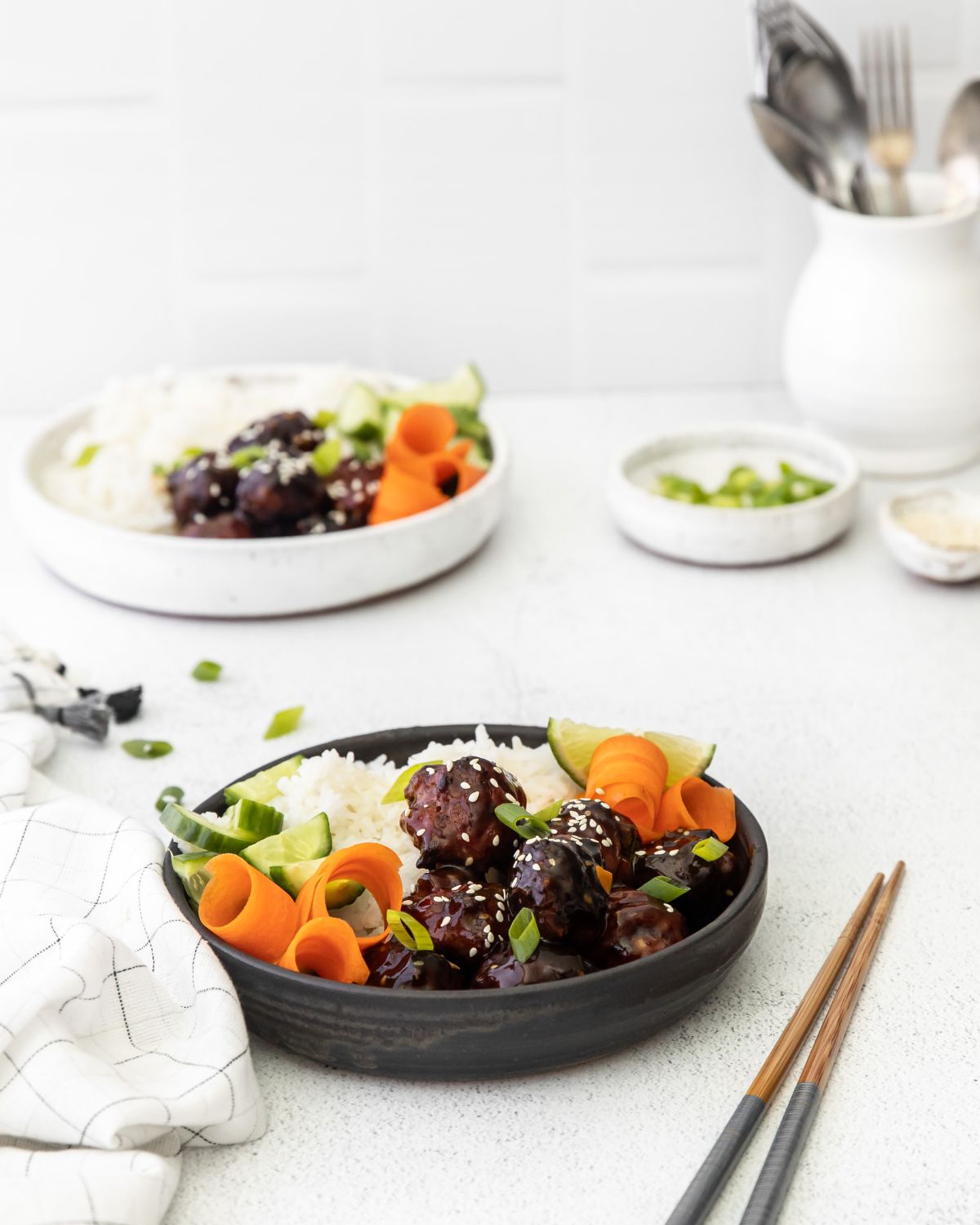 Asian ginger meatballs in a bowl with rice and carrots.