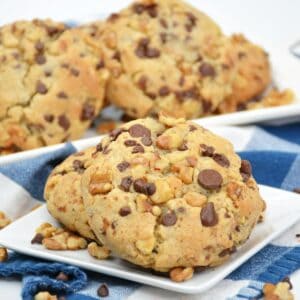 A stack of cookies with chocolate chips and nuts that are Levian chocolate chips.
