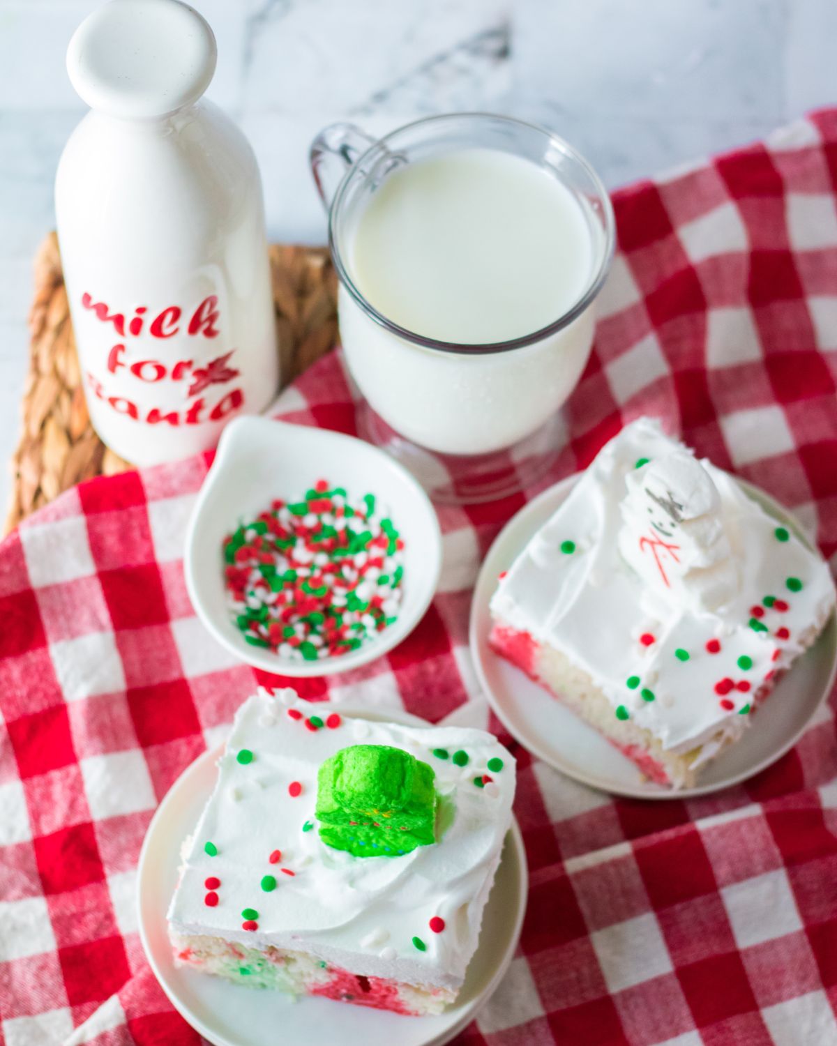 Slices of holiday poke cake with milk on the side.