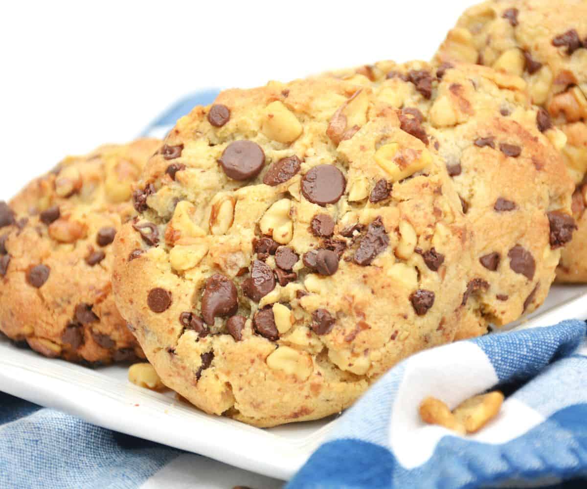 A white plate with chocolate chip nut cookies on a plate that are copycats of Levian Bakery.