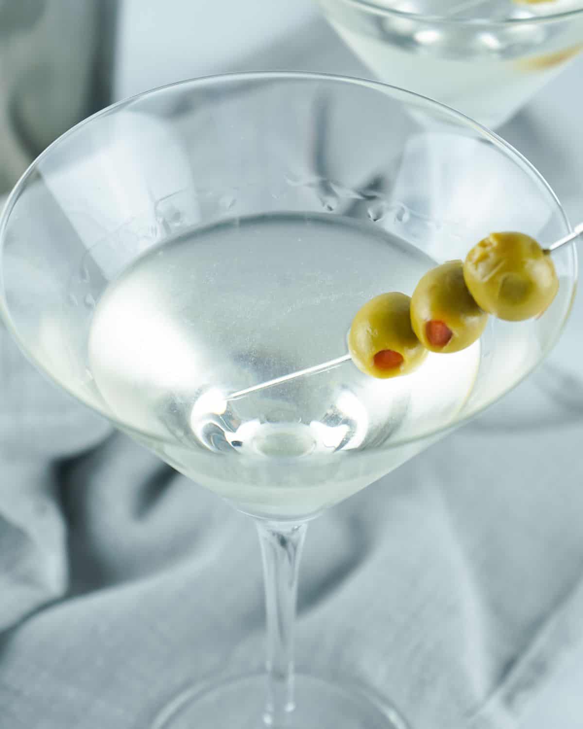 An overhead view of a gin martini with olives.